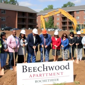 Groundbreaking ceremony for Beechwood Family Apartments with community members and construction equipment.